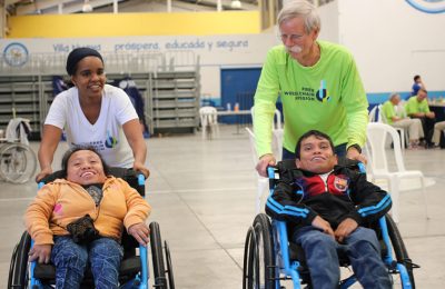 CEO Nuka Solomon and Founder Don Schoendorfer give wheelchairs in Guatemala.