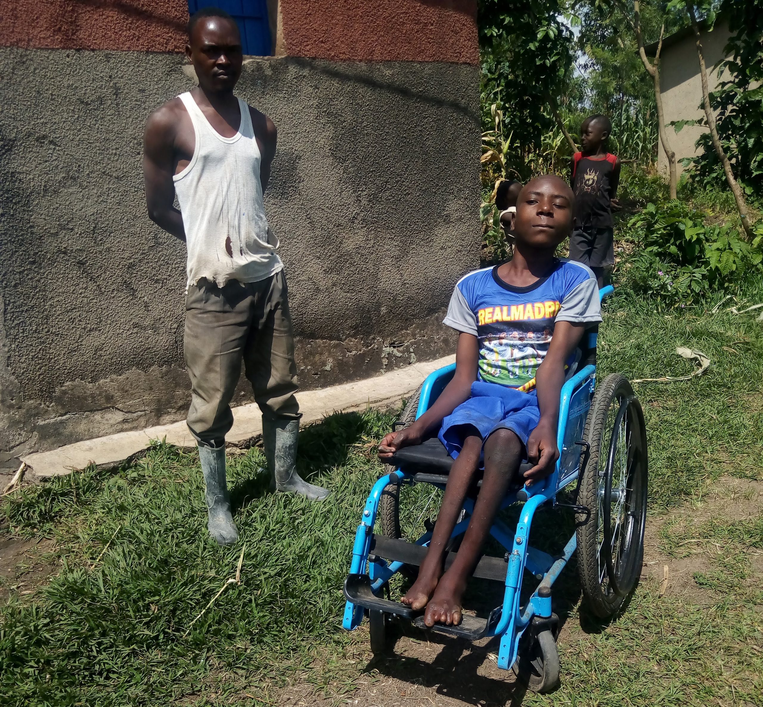 A young boy receives a new wheelchair in Rwanda