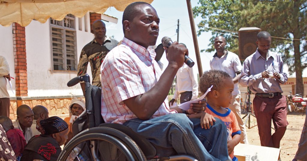 In Uganda, Francis speaks to a crowd from a wheelchair.