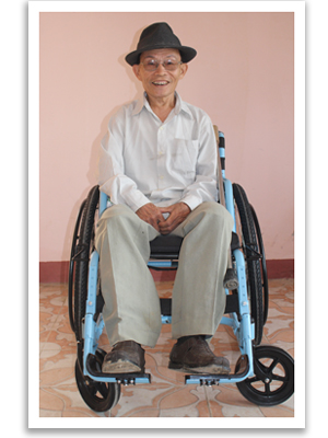 Ngoc receives a new wheelchair in Vietnam after losing his legs to a landmine.