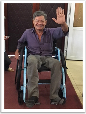 A man in Vietnam who received a new wheelchair after losing mobility to the effecs of Agent Orange.