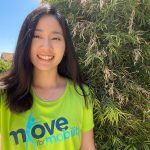 A young woman wears the Move for Mobility tee shirt.
