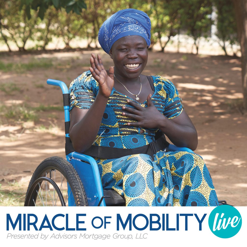 A woman in Kenya waves from her wheelchair.