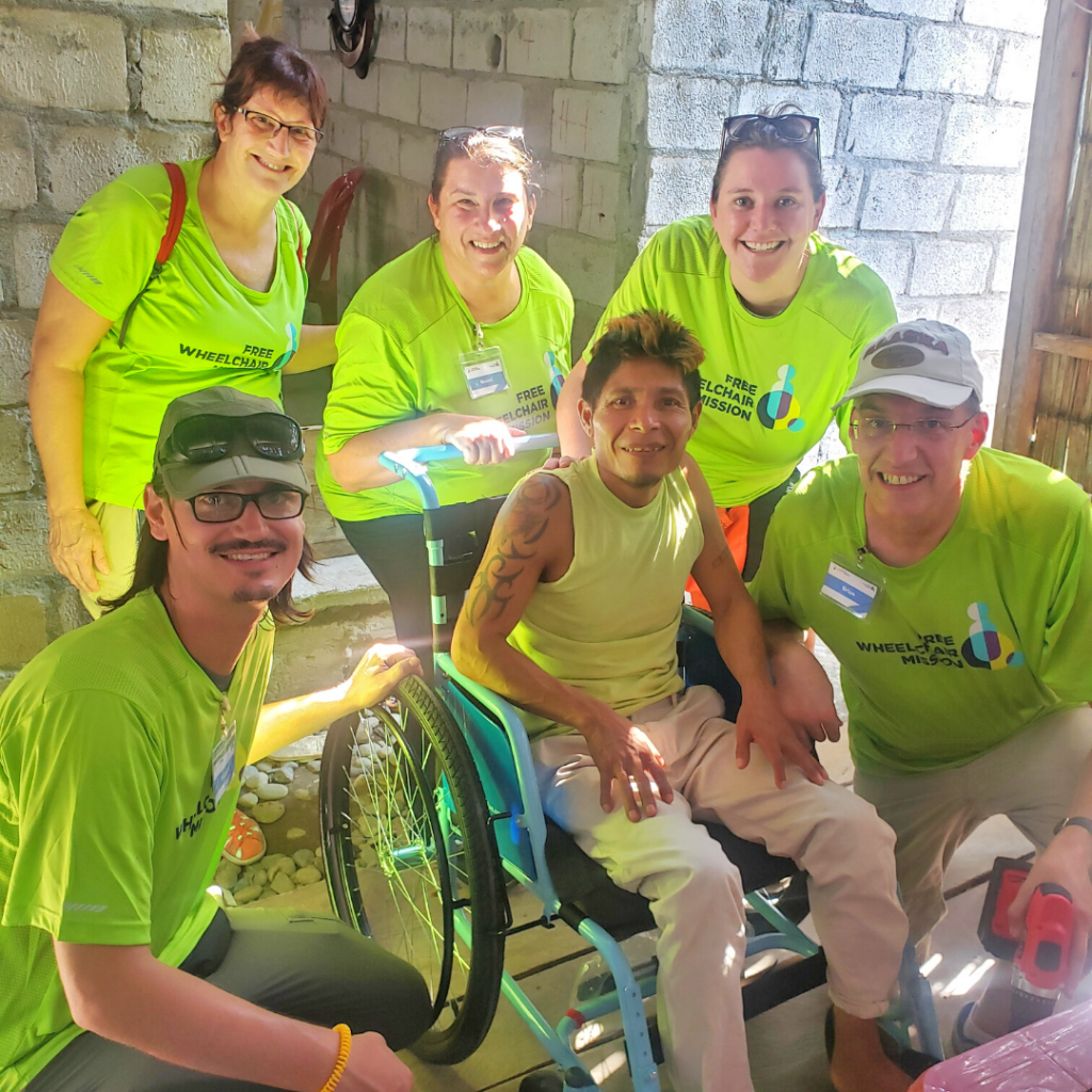 A team in Ecuador gives a new wheelchair to a young man