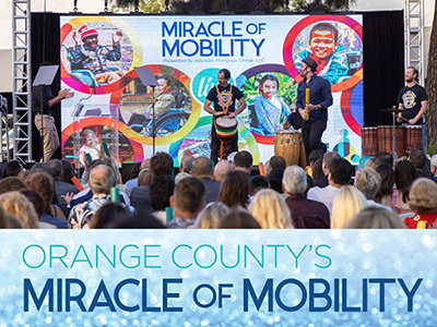 Orange County's Miracle of Mobility logo, with a photo of an audience watching a show on stage.