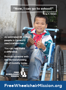 A smiling Vietnamese boy in a blue wheelchair.