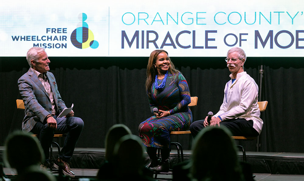 Three key speakers on stage during the Free Wheelchair Mission Miracle of Mobility event.
